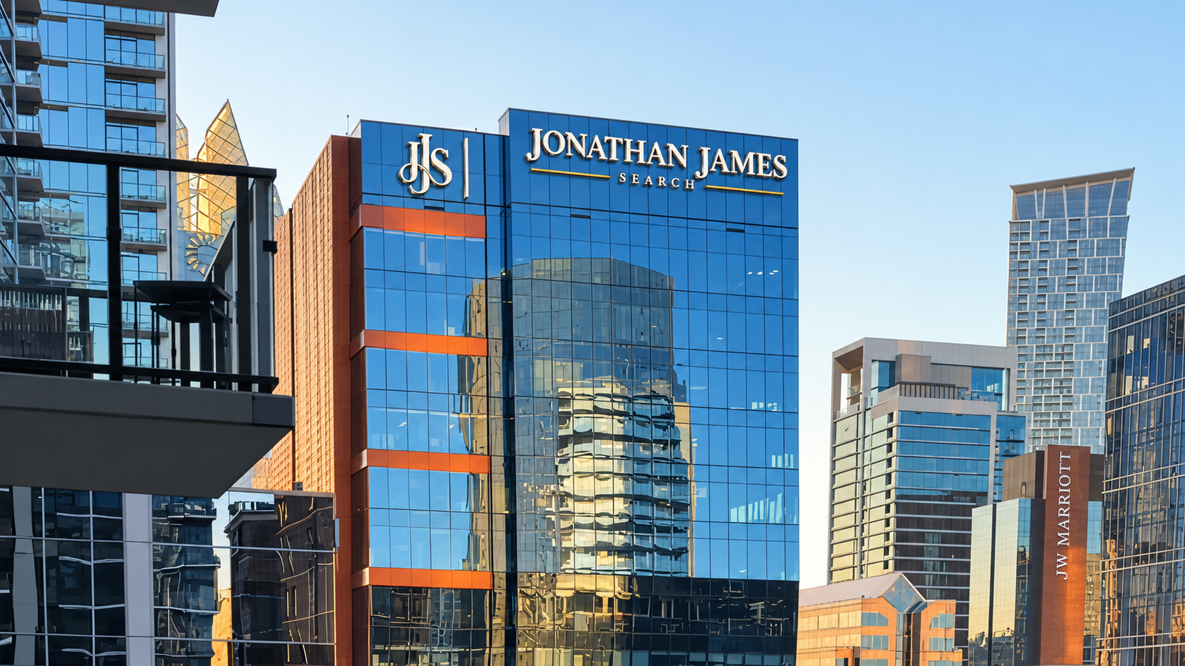Jonathan James Search neon branding on the glass building at night